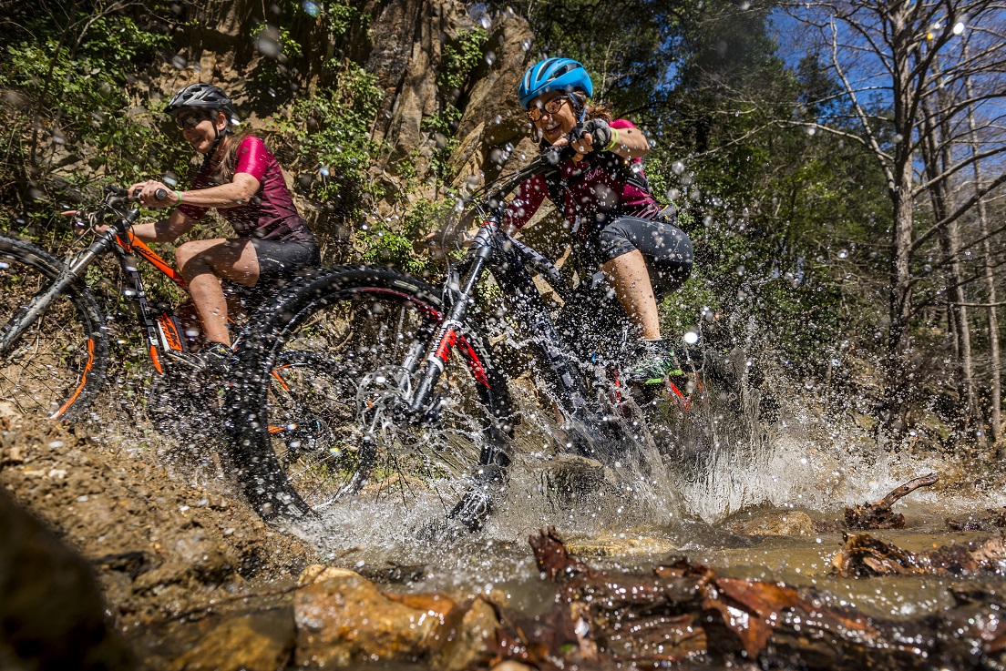Cyclists crossing a small river